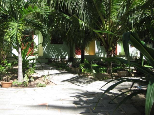 un patio con palmeras y un edificio en Cocosand Hotel, en Mui Ne