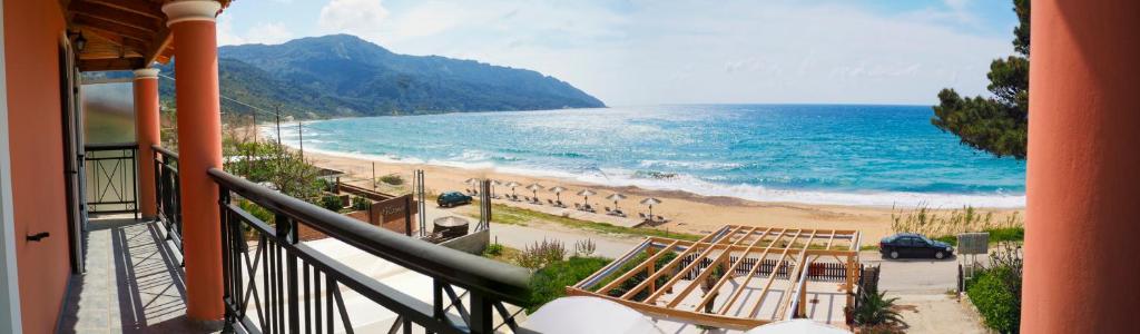 
a beach with a view of the ocean at Maria Apartments in Agios Georgios Pagon
