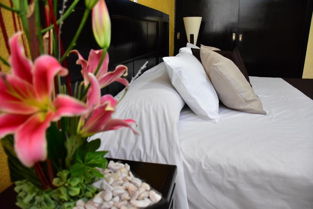 Postel nebo postele na pokoji v ubytování Hotel Suite Azomali