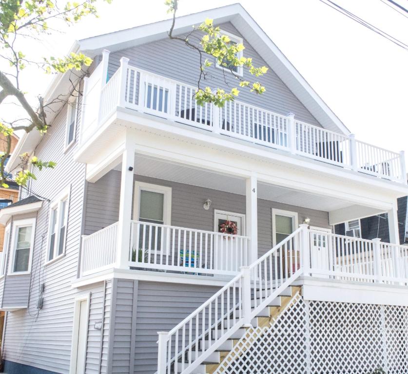 a white house with a white porch and white railings at Lux 3 Bd - Perfect & Parking & Massive Patio in Ventnor City