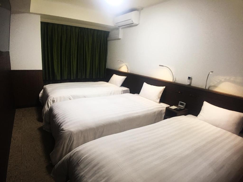 Postel nebo postele na pokoji v ubytování High Set HOTEL SHIZUOKA Inter