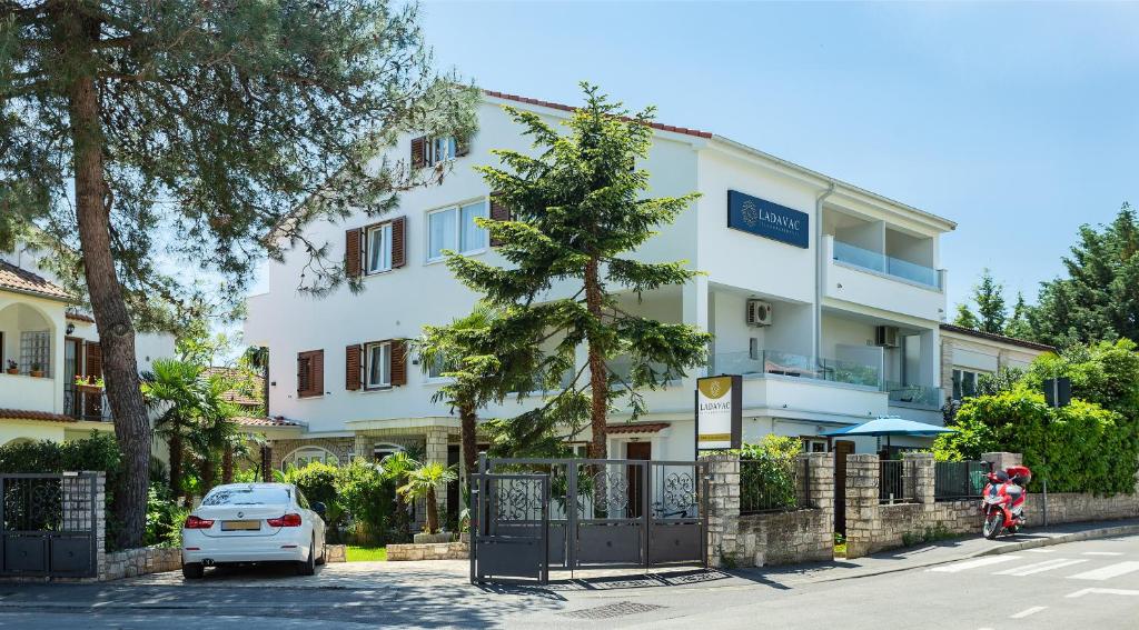 a white car parked in front of a building at Villa Ladavac B&B in Rovinj