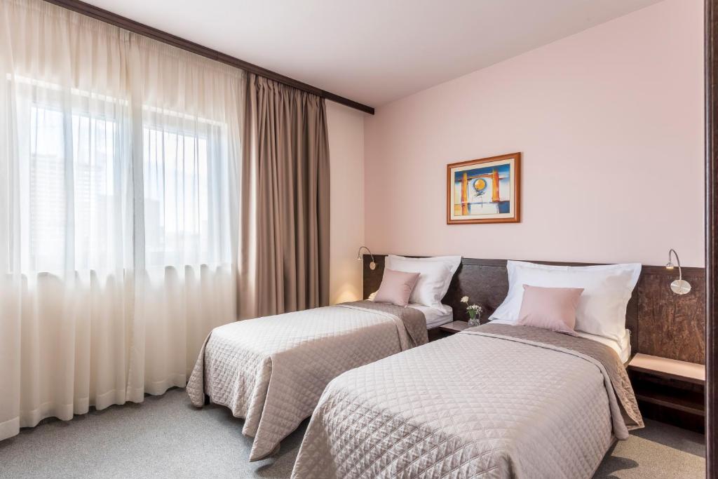 Posteľ alebo postele v izbe v ubytovaní Hotel As