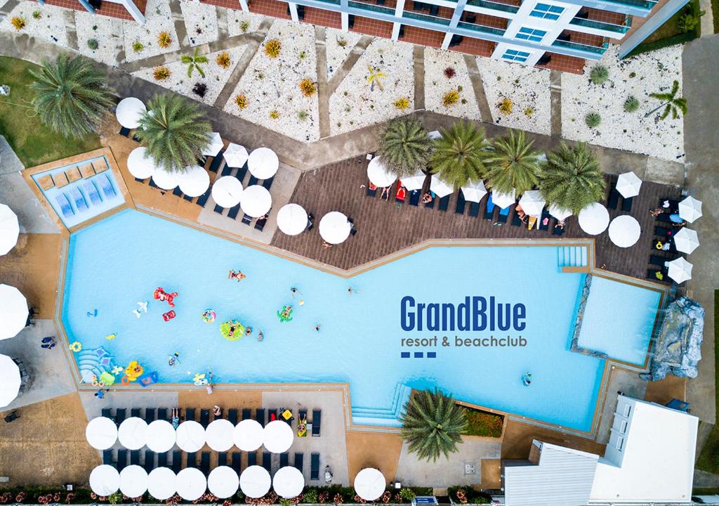 an overhead view of a pool at a resort at GrandBlue Resort & Beachclub in Mae Pim