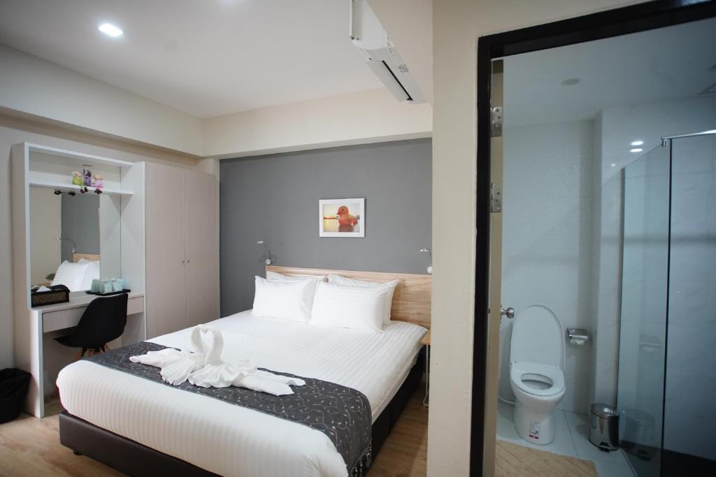 Tisa Hotel Udonthani tesisinde bir odada yatak veya yataklar