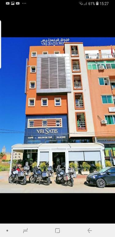 a building with motorcycles parked in front of it at Hotel VELSATIS in Beni Mellal