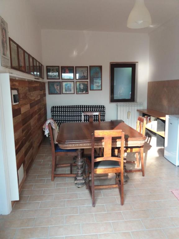 a dining room with a table and chairs and a television at CAMPO BASE B&B in SantʼAngelo in Pontano