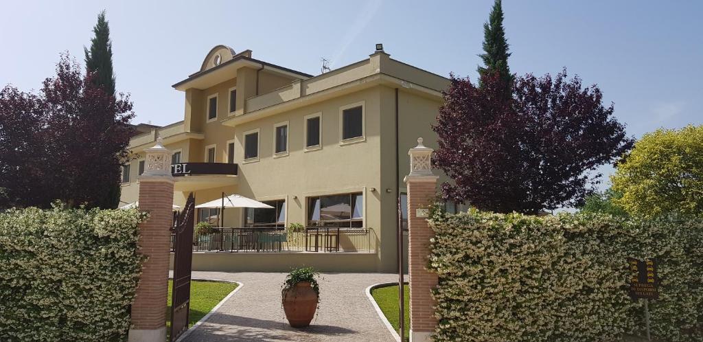 a large house with a gate in front of it at Giga Hotel in Villa Santa Lucia