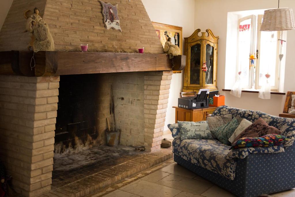 a living room with a couch and a fireplace at Casa Rana in Recanati
