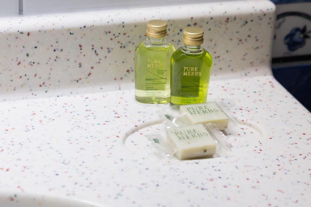 two bottles of soap sitting on a table at Hotel Perrin - former Carlton in Luxembourg