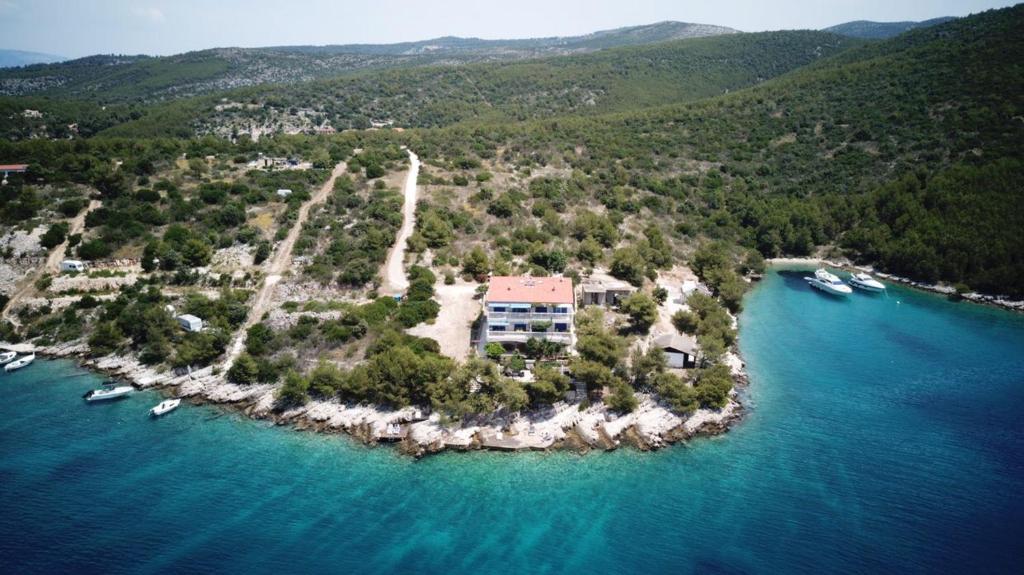 an island in the ocean with boats in the water at Sunset Villa Hvar in Hvar