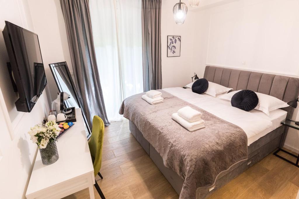 a bedroom with a bed with towels on it at Luxury rooms with balcony in Zadar