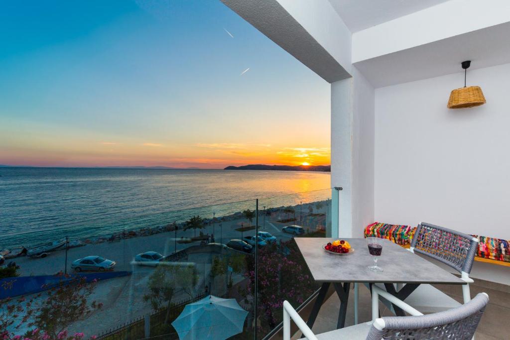 balcón con mesa y vistas al océano en Pension Ageri, en Potos