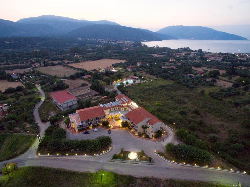 an aerial view of a resort with a lake and mountains at Hotel Pericles in Sami