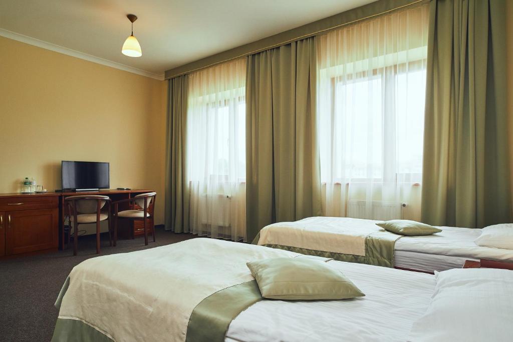 Postel nebo postele na pokoji v ubytování Hotel Patriarshyi