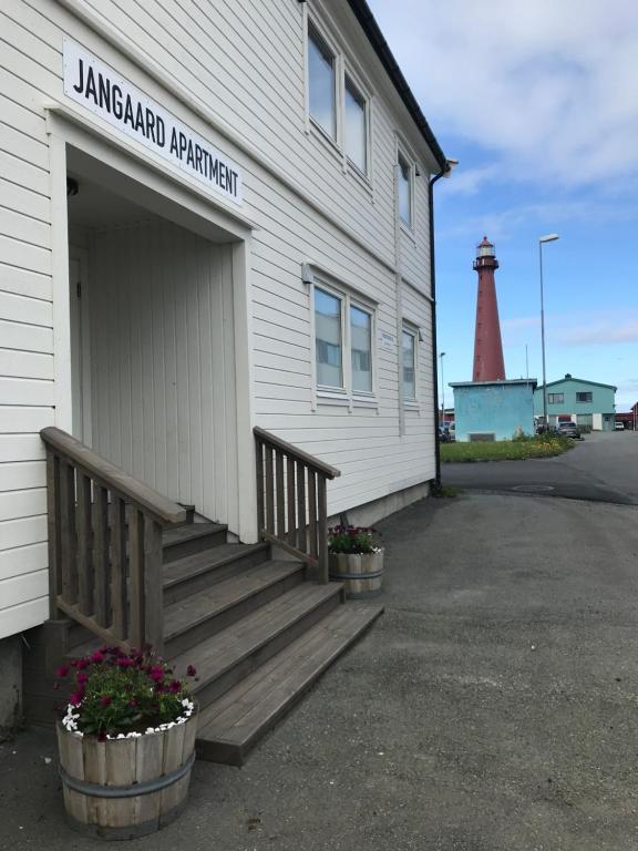 a building with a staircase and a lighthouse at Jangaard Apartment in Andenes