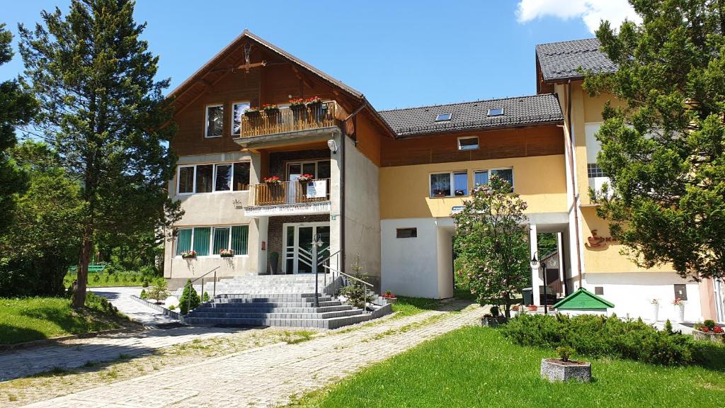 a large house with stairs in front of it at OKW Pilsko in Korbielów