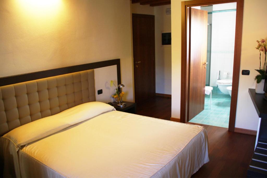 Postel nebo postele na pokoji v ubytování Hotel Le Macine