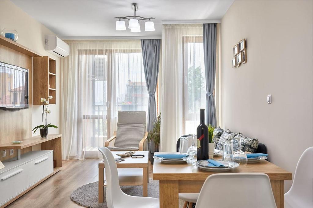 a kitchen and dining room with a table and chairs at RELAX CENTER Burgas & Free PARKING in Burgas City