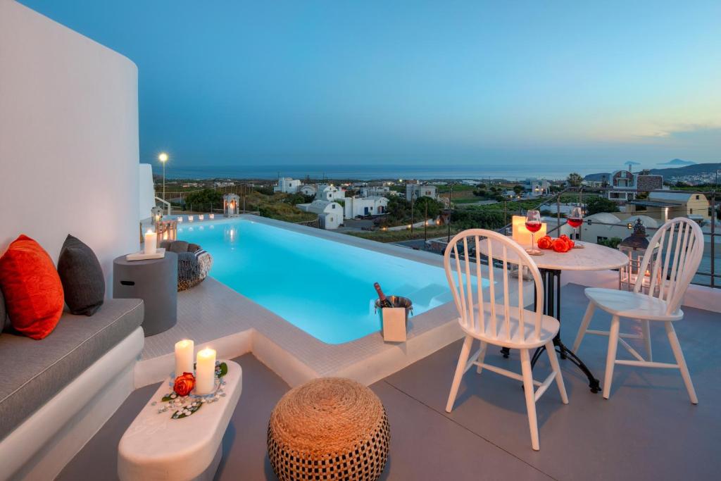 a villa with a swimming pool and a living room at MILESTONE VILLAS in Megalochori