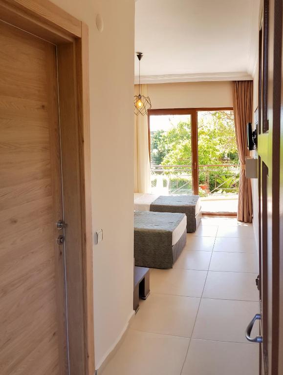 a room with two beds and a window at Papirus Hotel in Adrasan
