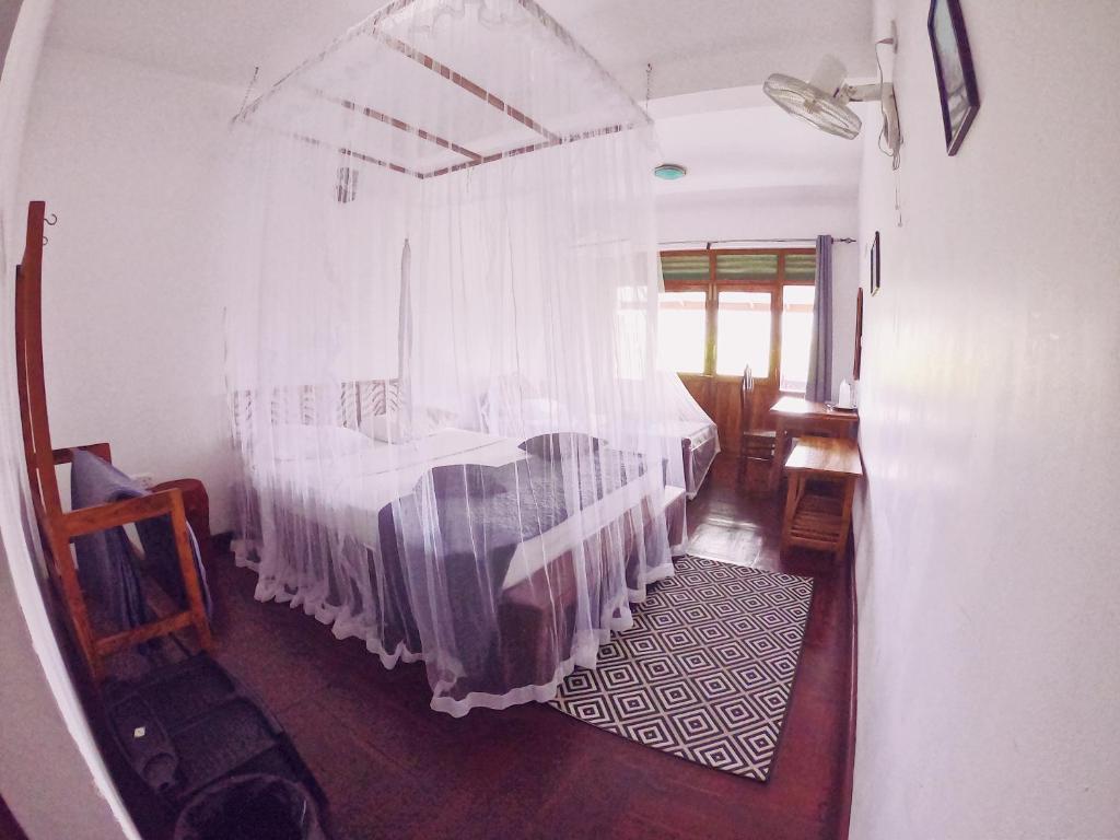 Postel nebo postele na pokoji v ubytování Lakshmis Hotel Ella