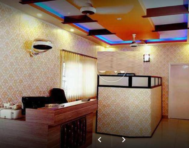 a room with a kitchen with a ceiling with at E-Town Rooms Guest House in Karachi