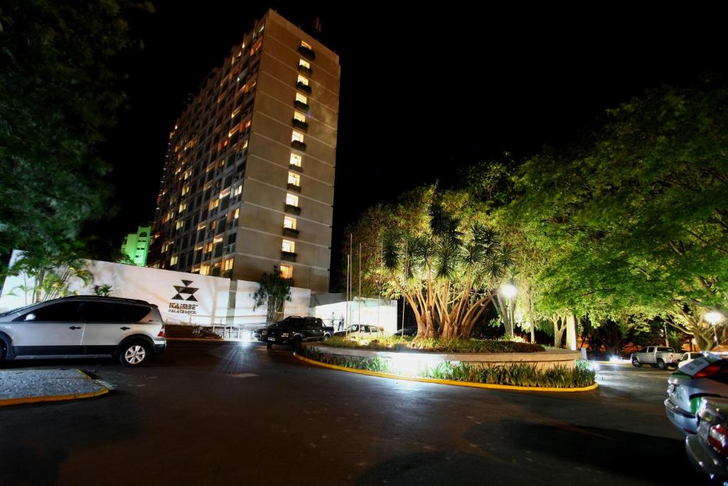 a parking lot in front of a building at night at Itaimbé Palace Hotel in Santa Maria