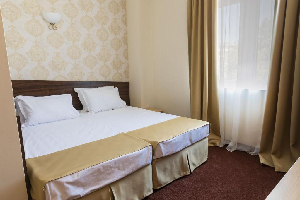 Postel nebo postele na pokoji v ubytování Hotel Central