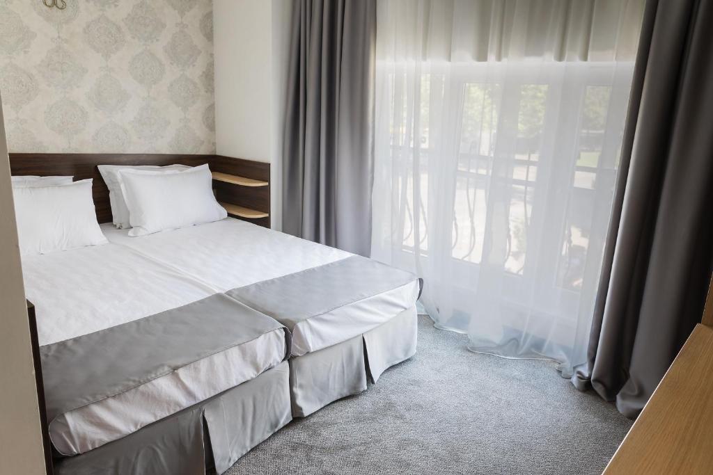 Postel nebo postele na pokoji v ubytování Hotel Central