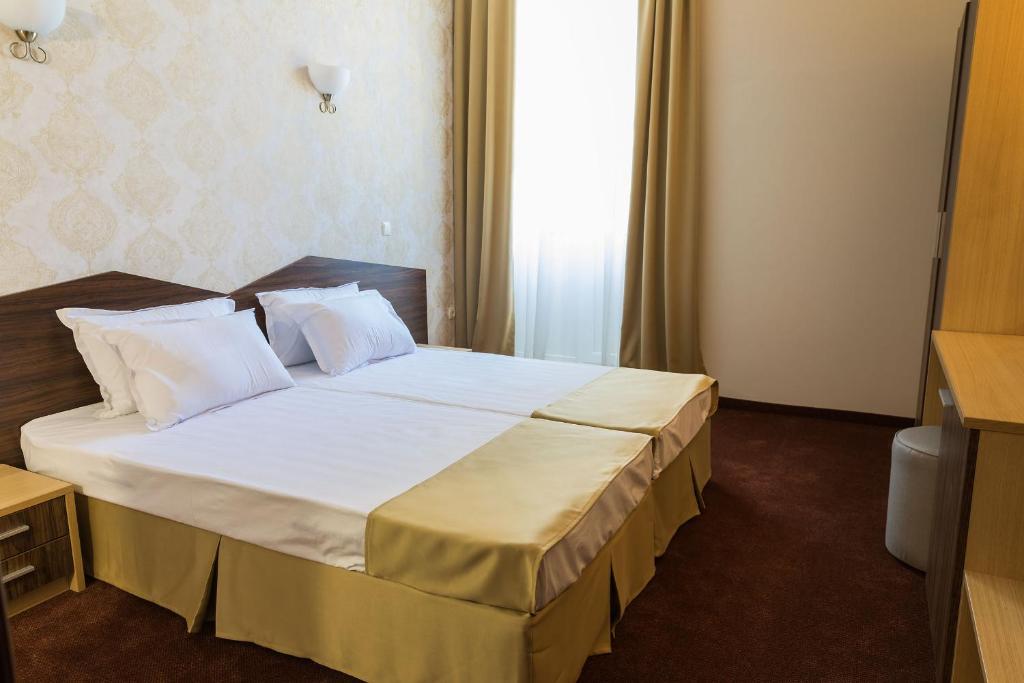 Postel nebo postele na pokoji v ubytování Hotel Central