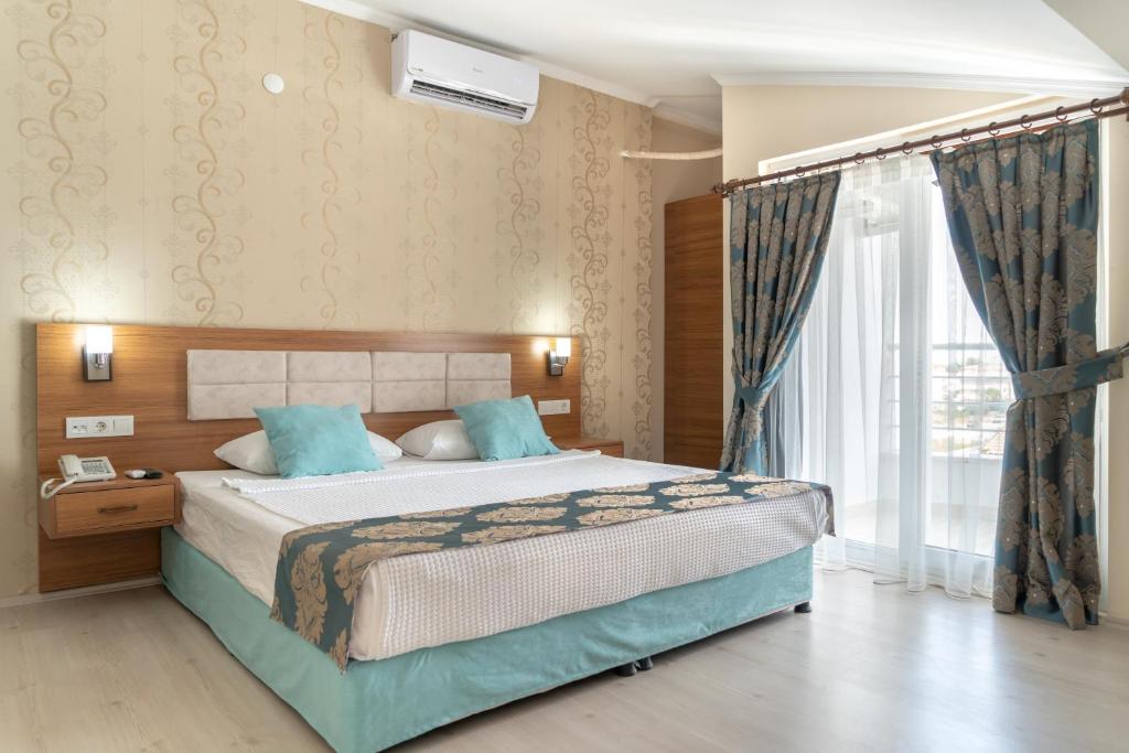 Postel nebo postele na pokoji v ubytování OLYMPIC HOTELS Belek