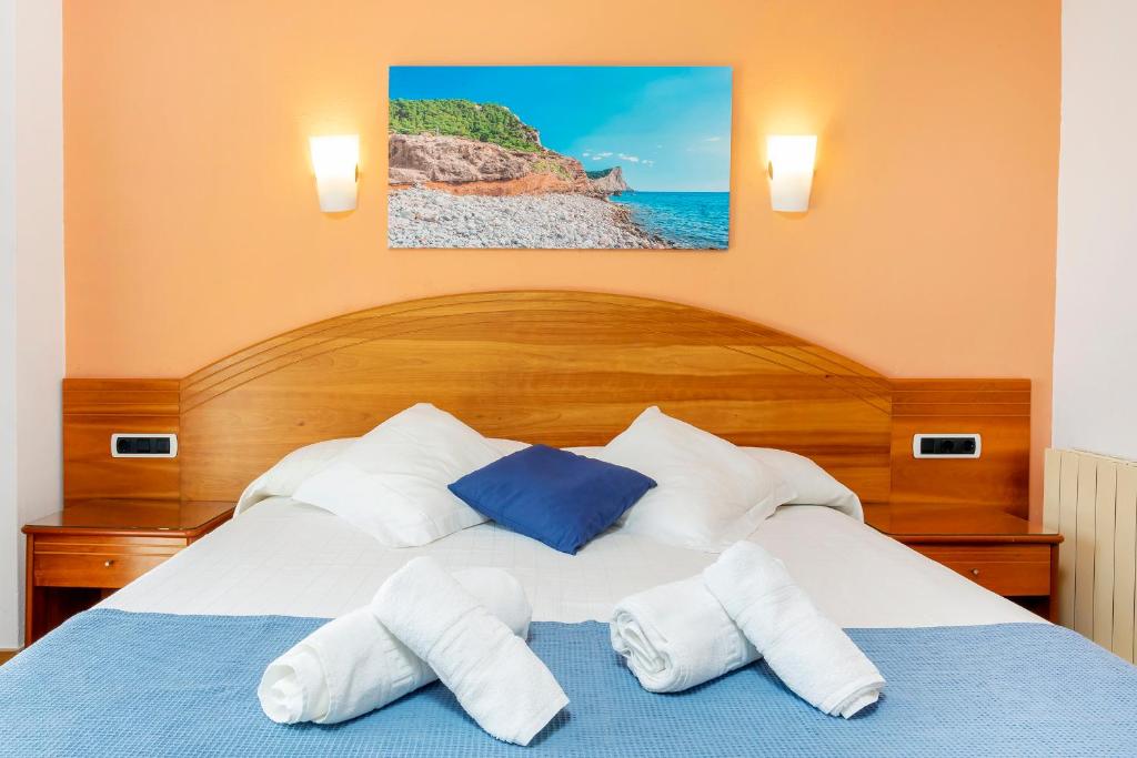 Postel nebo postele na pokoji v ubytování Hostal Manolita