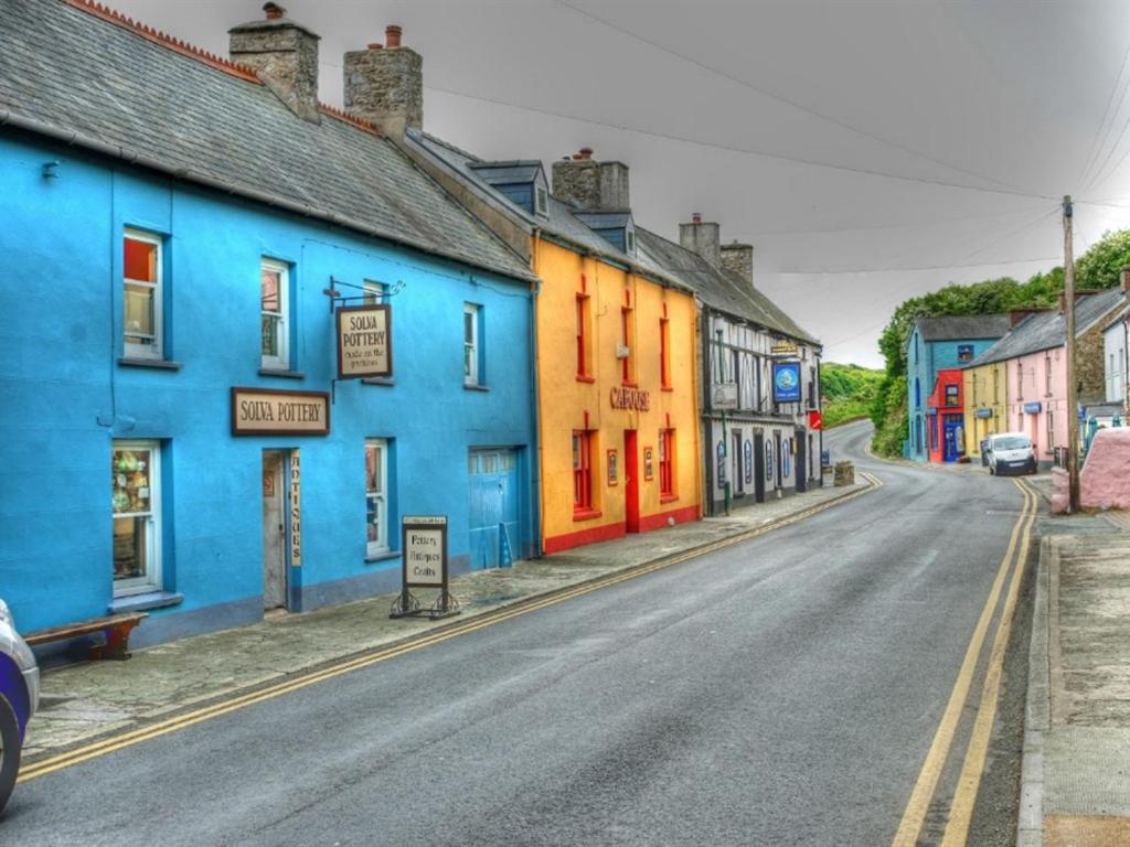 an empty street with colorful houses on a street at The Ship Inn in Solva