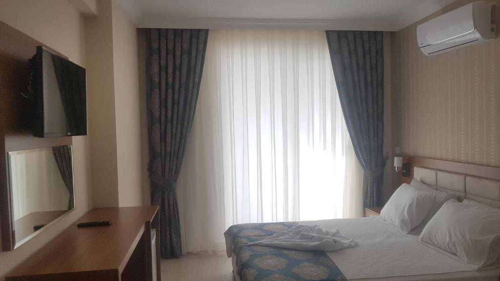 Postel nebo postele na pokoji v ubytování OLYMPIC HOTELS Belek