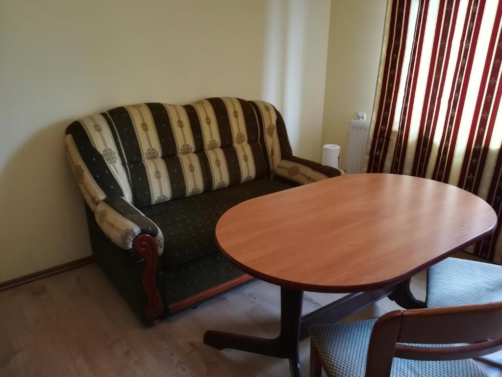 a living room with a couch and a table at Apartament Europejskiej Stolicy Kultury in Wrocław