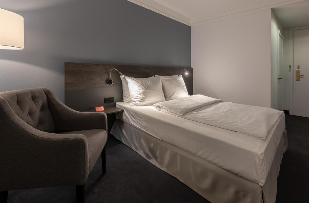 Postel nebo postele na pokoji v ubytování Lindgart Hotel Minden