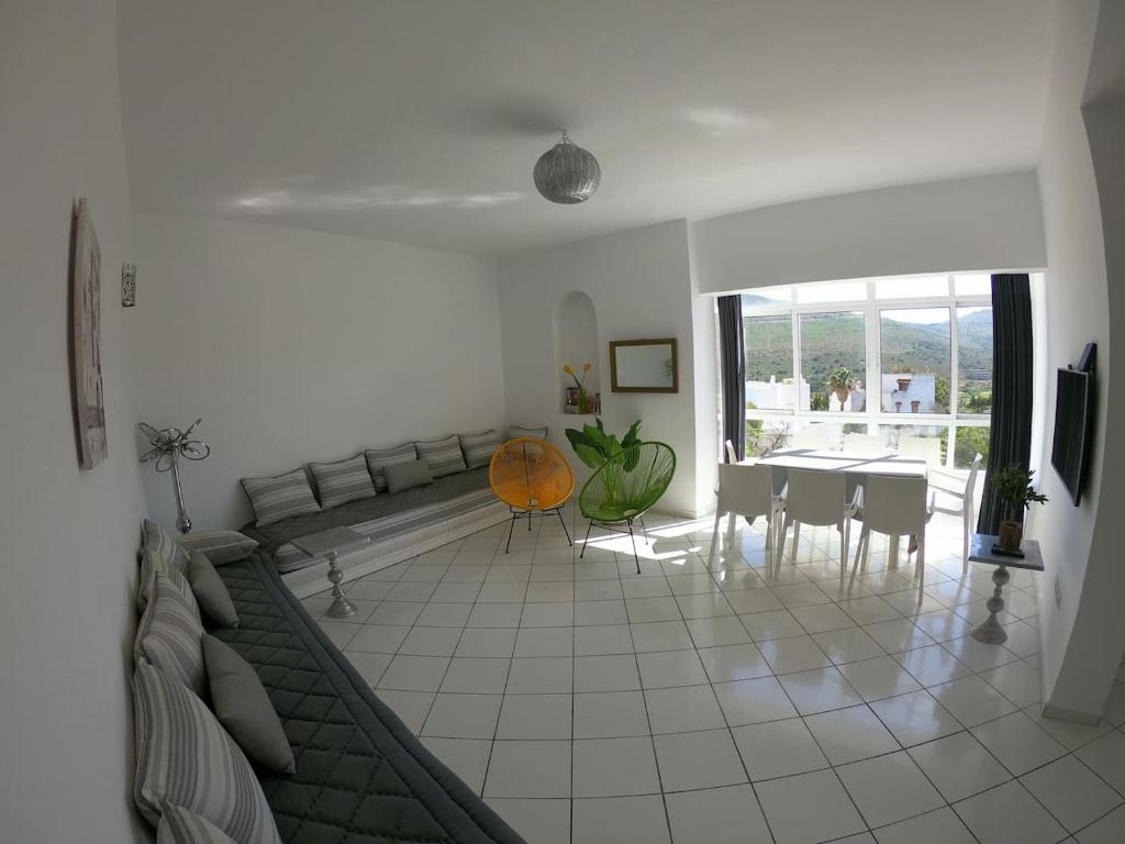 a living room with a couch and a table at Tanger Cap Spartel - Duplex 110m2 face aux plages in Tangier