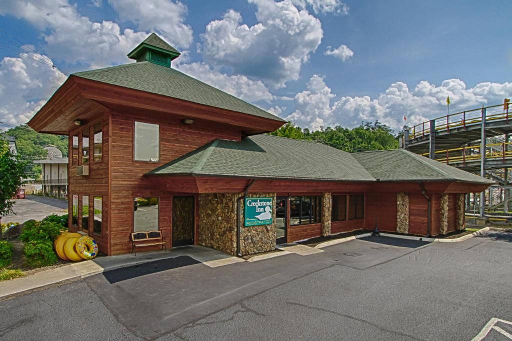 a building with a sign on it in a parking lot at Creekstone Inn in Pigeon Forge