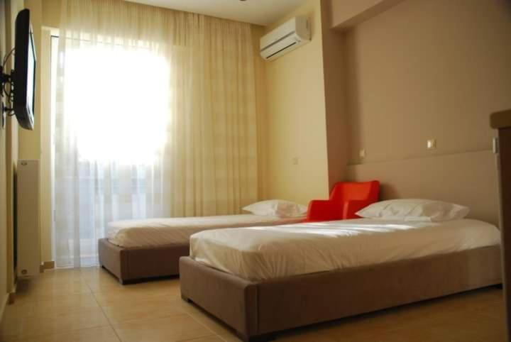 Postel nebo postele na pokoji v ubytování LESSIOTI APARTMENTS
