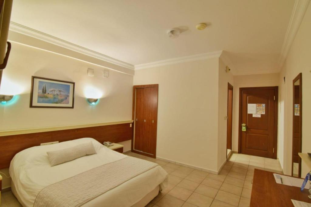 A bed or beds in a room at Olympos Hotel - Adults Only