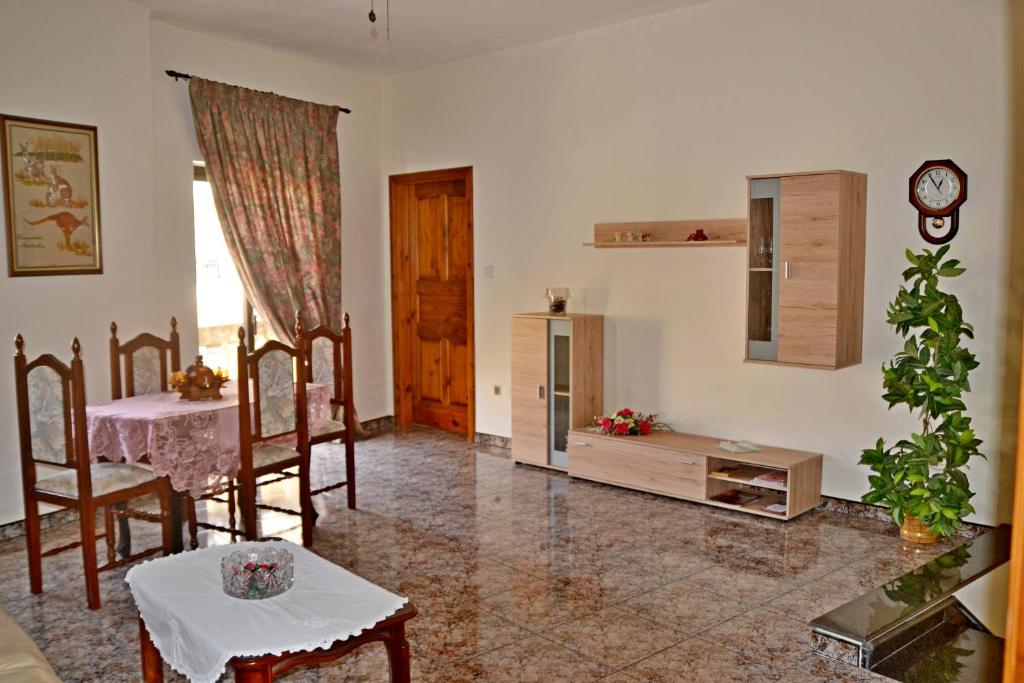 a living room with a table and a dining room at Silia's Maisonette in Marsaskala