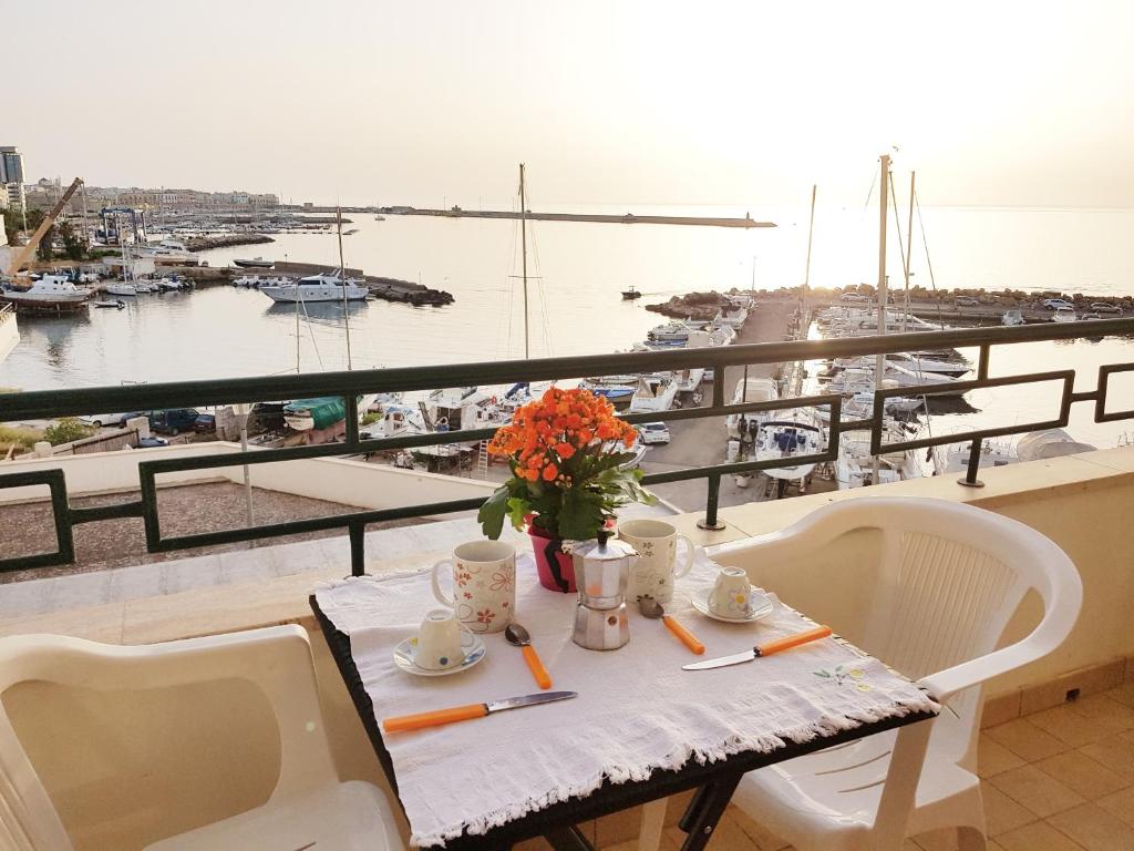 einen Tisch und Stühle mit Blick auf den Yachthafen in der Unterkunft Pleasure in Gallipoli