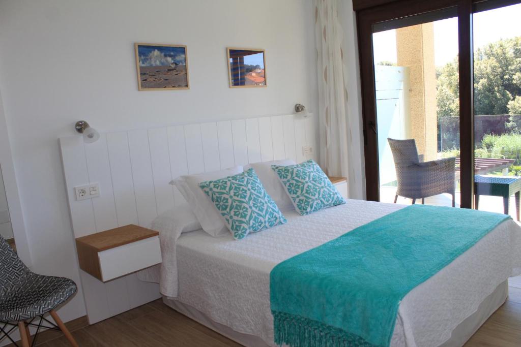 Postel nebo postele na pokoji v ubytování Apartamentos As Lagoas
