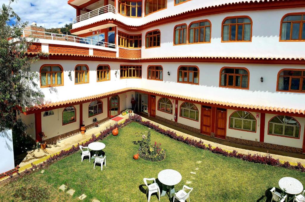 an external view of a building with tables and chairs at Morales Guest House in Huaraz