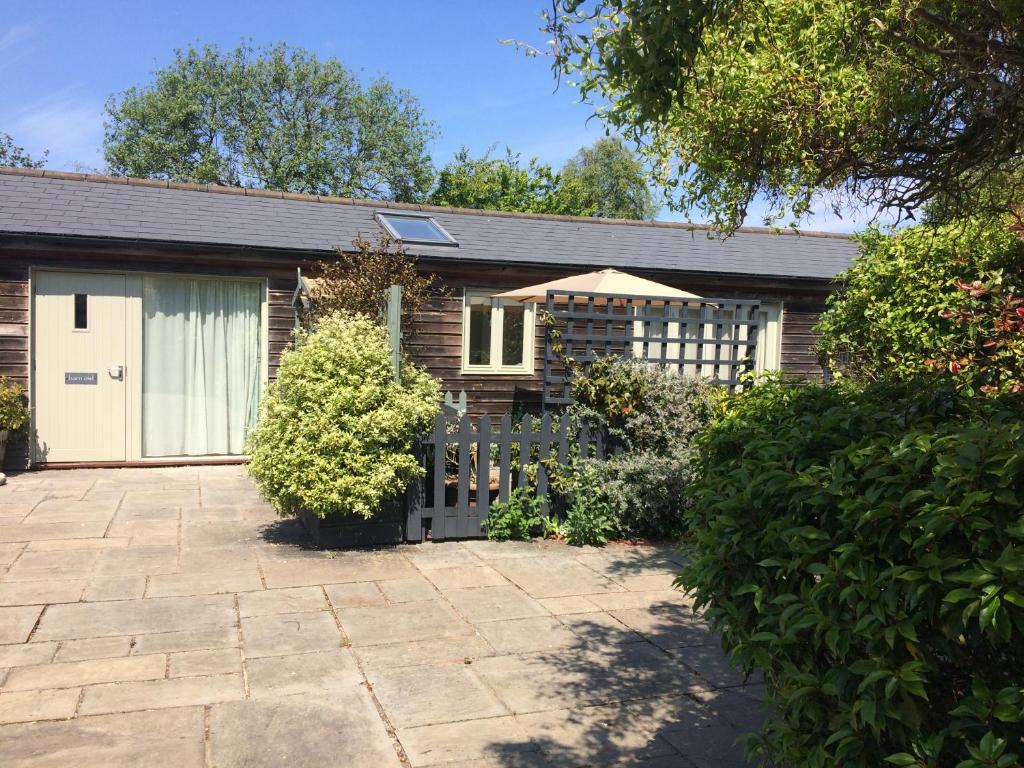 a house with a fence and a patio at Barn Owl in Happisburgh