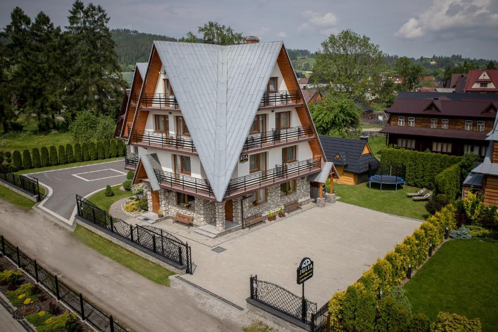a large house with a large white roof at Dom Wypoczynkowy Julia in Białka Tatrzańska