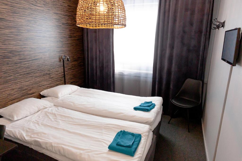 Postel nebo postele na pokoji v ubytování CarlstadCity H Boutique Hotell