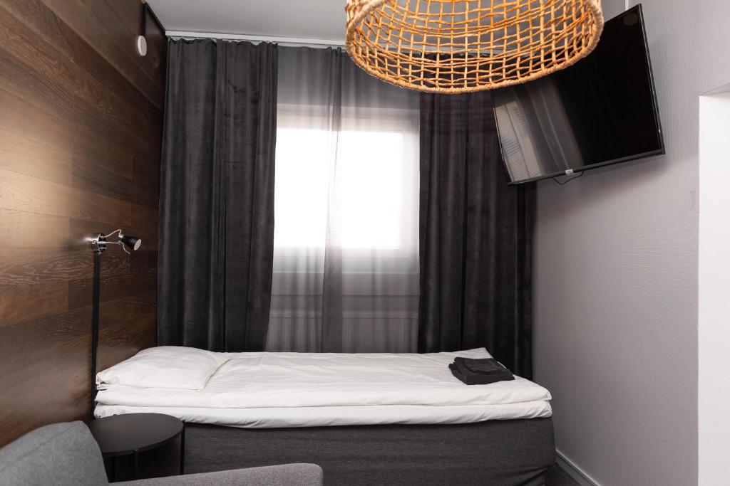 Postel nebo postele na pokoji v ubytování CarlstadCity H Boutique Hotell