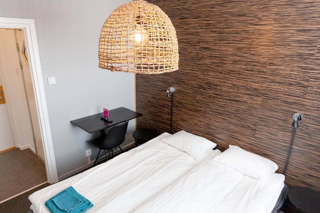 Postel nebo postele na pokoji v ubytování CarlstadCity H Boutique Hotell